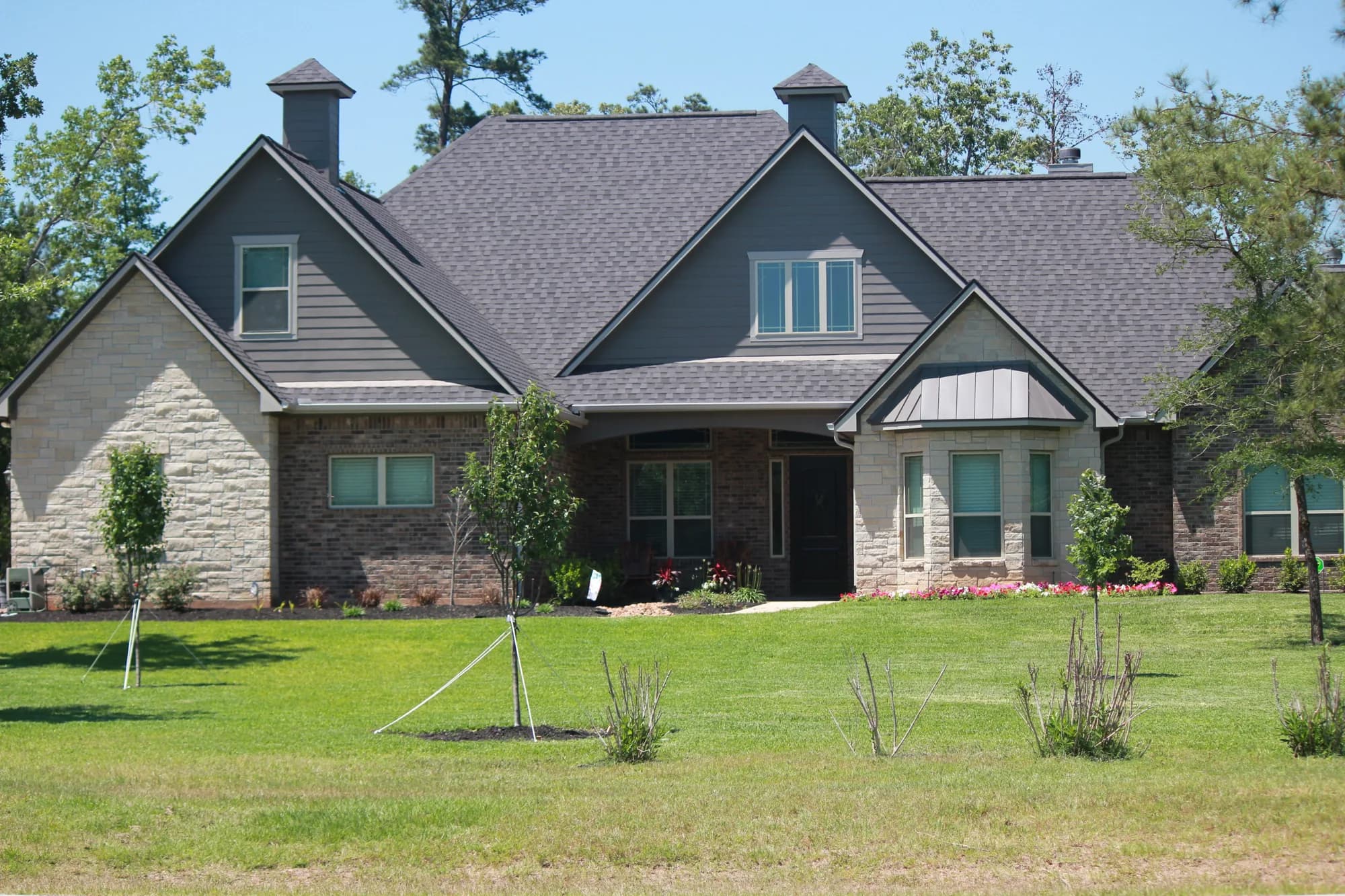 Stone and shingle custom home built by QBS in Montgomery County, Texas